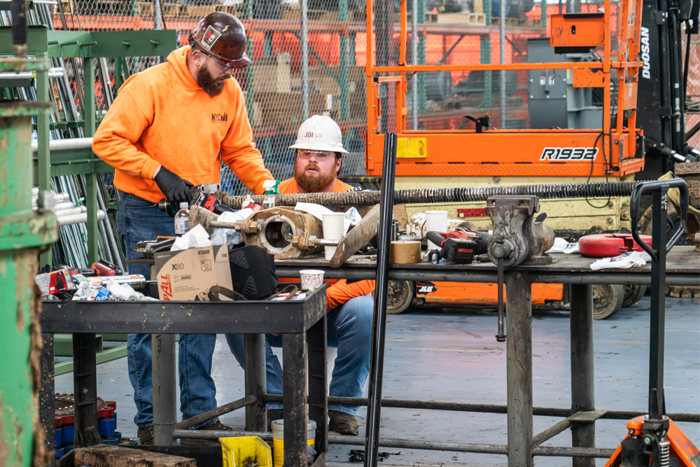 Maintenance team working on machinery at paper mill