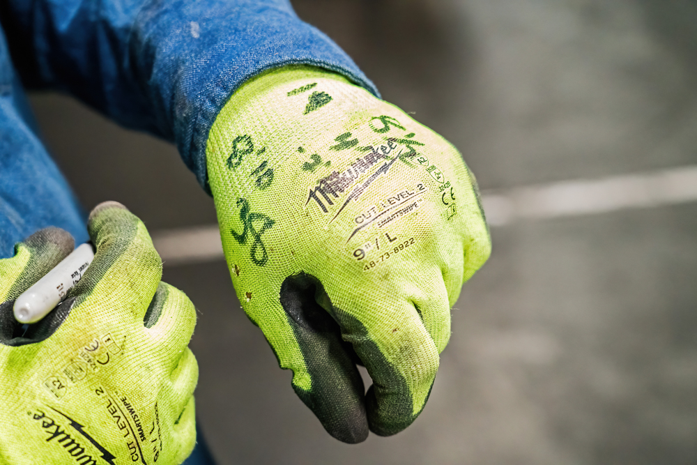 JDI Industrial worker's hand with measurements on it