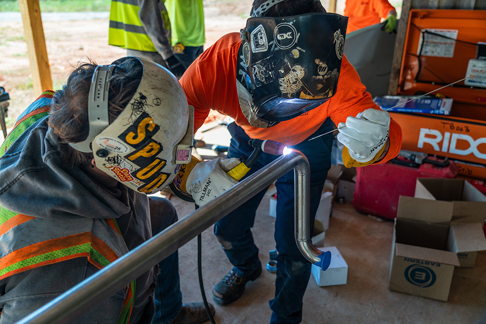 Pipefitting crew working on stainless steel piping