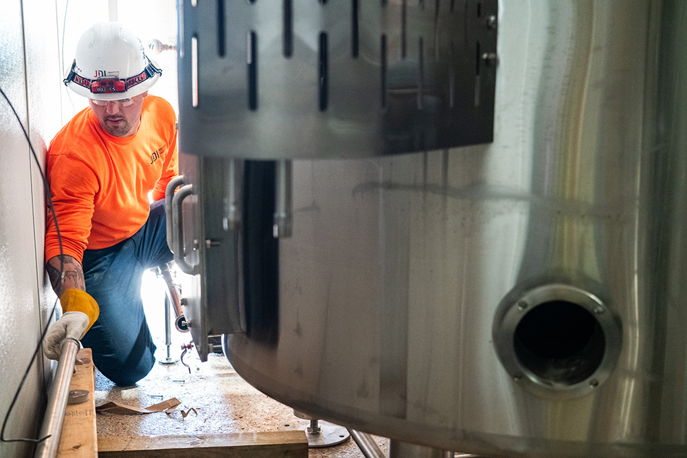 sanitary piping installation into stainless brewing tanks