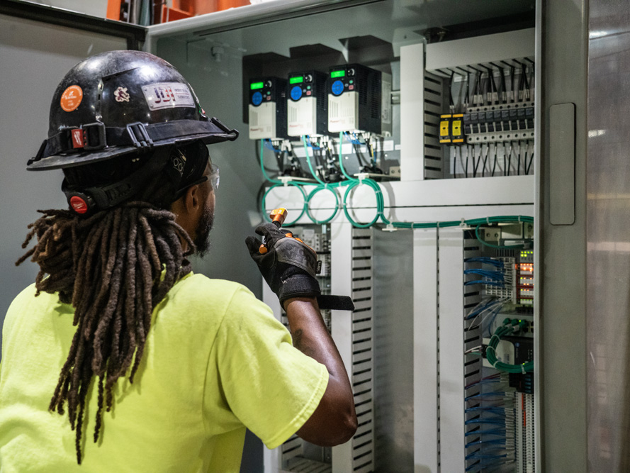 Electrician inspects motor control center