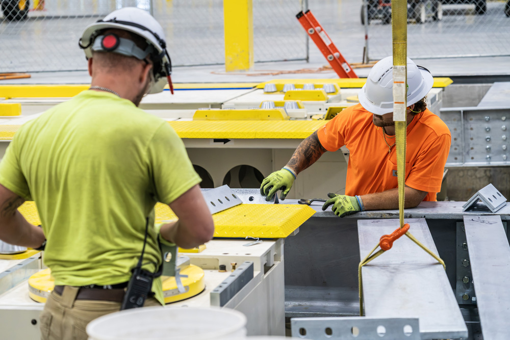 JDI crew bolting together the automotive steel package